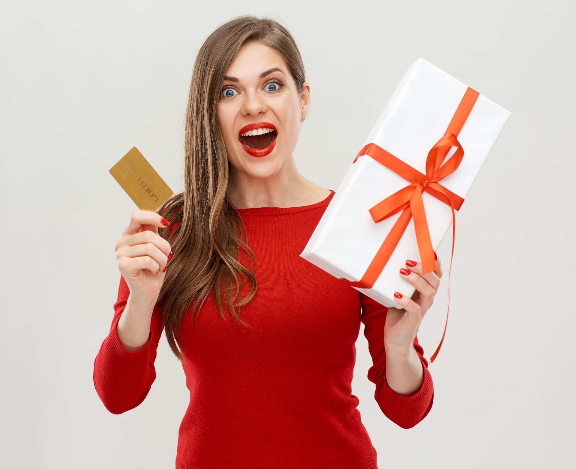 portrait of happy woman holding gift box with credit card